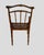 A set of four beatiful faux-bamboo arm chairs, each featuring cane seats.