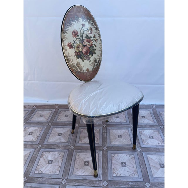 Medallion Designer Chair from the 1960s. This 1960s-style design chair features an oval backrest with a medallion floral...