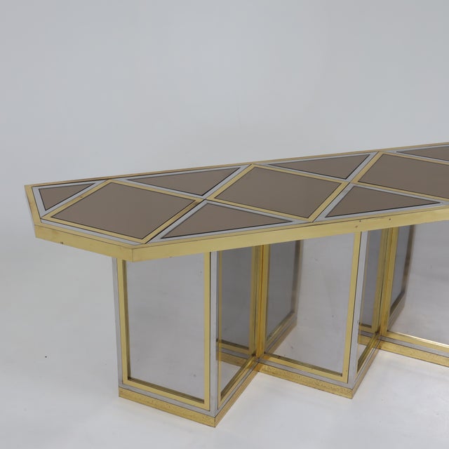 Italian Modernist console table attributed to Sandro Petti. Patinated brass, chrome and mirrored glass laid out in a...