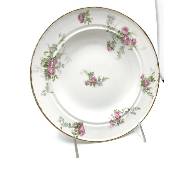 Pink and blue/purple floral hand painted with green leaves. Bowl has gold leaf on edges. Beautifully made French bowl. Goa...
