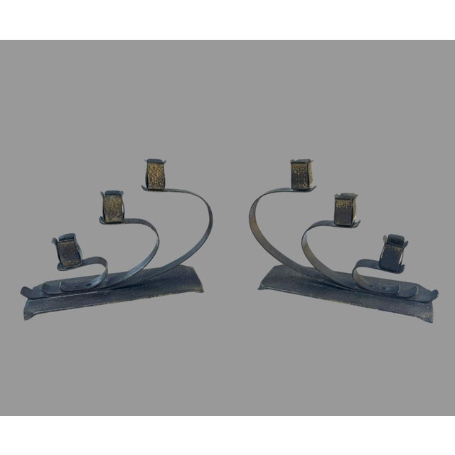 Wonderful matched pair of antique Arts & Crafts three-light candelabras, dating to approximately the early 20th century....