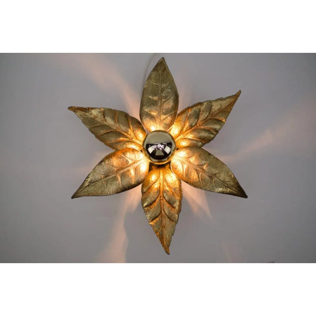 A wall lamp by belgian designer willy daro for lighting manufacturer massive. It has a naturalistic shape and is...