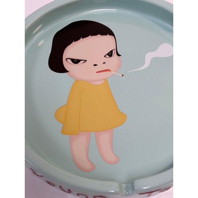 Yoshitomo Nara's " Too Young to Die" (2002) is a highly popular, collectible glazed ceramic ashtray featuring one of his...