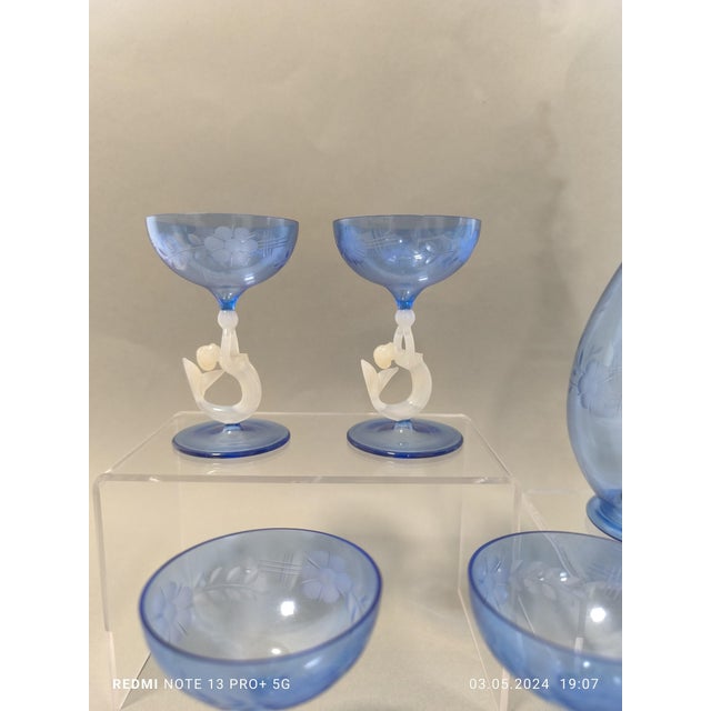 A super rare liqueur set in enchanting blue hand-cut glass with white mermaids from Lauscha, consisting of five beautiful...