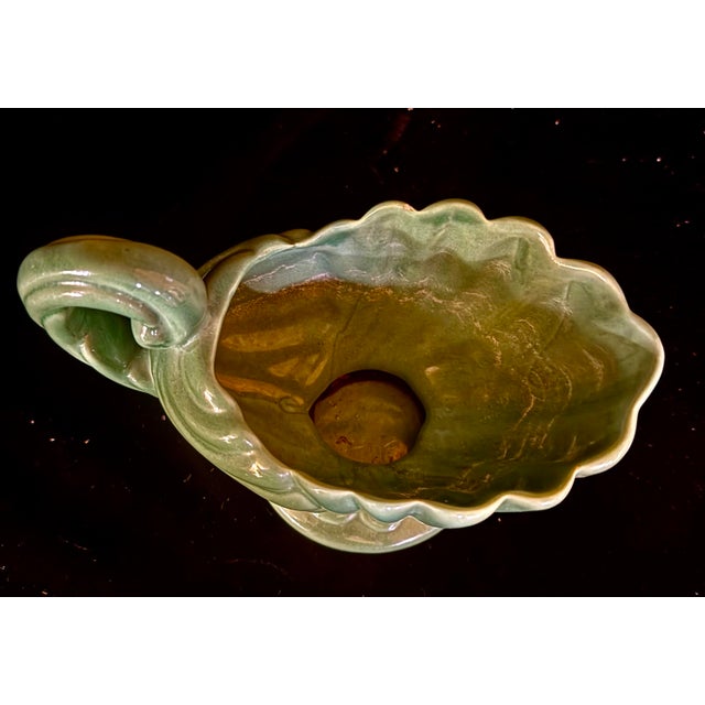 This piece functions as a decorative tabletop planter, vase, or a standalone decorative ewer or centerpiece, capturing the...