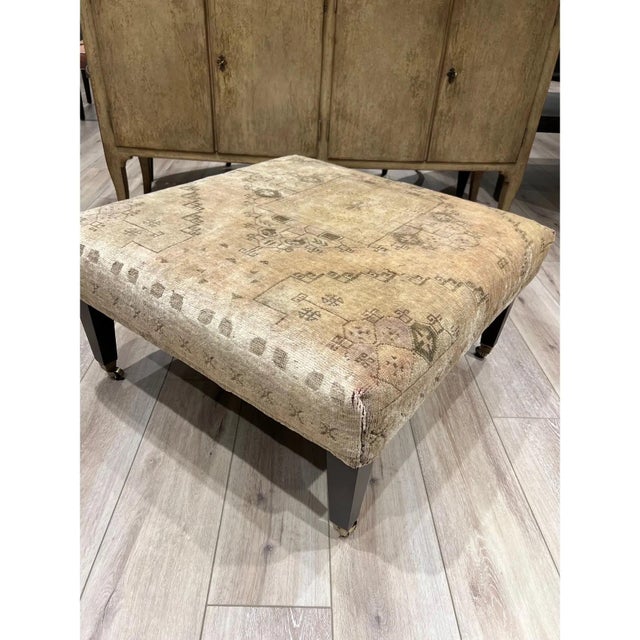 beautifully proportioned square ottoman, upholstered in a richly faded antique rug. The textile’s intricate geometric...