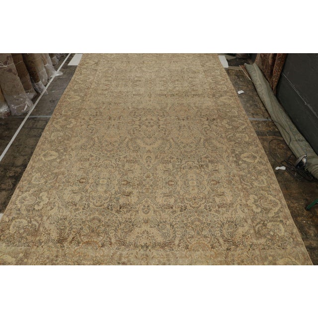 An antique 12x21 Persian Kerman rug, hand-knotted in wool circa 1920s. Further On the Design: This antique piece is a...