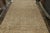 An antique 12x21 Persian Kerman rug, hand-knotted in wool circa 1920s. Further On the Design: This antique piece is a...