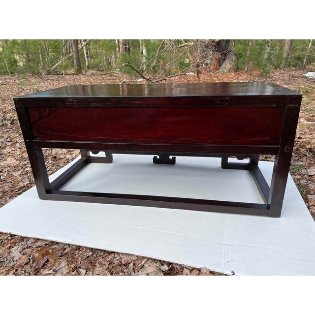 A single small rectangular antique Chinese hardwood low table with a single drawer. The Ming style stretcher base features...