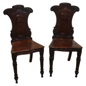 Late 19th Century Hand Carved Mahogany Armorial Hall Chairs - a Pair