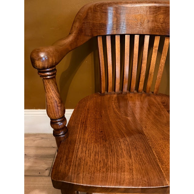 This stunning antique solid oak banker's chair by the W.H. Gunlocke Chair Company of Wayland, New York, perfectly balances...