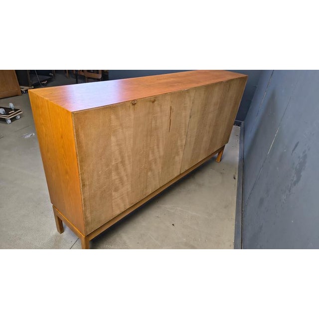 Vintage oak highboard by Belgian manufacturer VandenBerghe Pauvers. The 4 doors reveal plenty of storage space with 4...