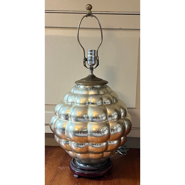 Mid-Century Modern silvered mercury glass table lamp circa 1950. Bulbous shape with many reflective surfaces. Measures 25...