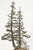 A Brutalist sculpture depicting two elongated trees in bronze, their delicate, branching forms rising from a rough-cut...