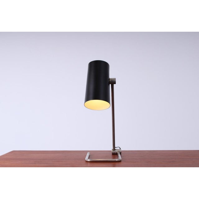 Elegant and quite large 1950ies lamp displays the exemplary talent of the mid-century German product- and lighting design....