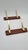 A pair of mid-century Danish wall hooks made of rosewood and brass-plated aluminum. They feature a minimalist, mid-20th-...