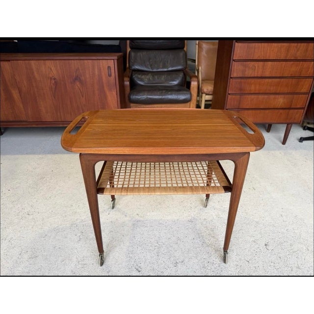 A Danish mid-century serving trolley by Johannes Andersen for Silkeborg circa 1960s. The trolley is in very good used...