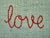 Custom made hand embroidered pillow. Woven "seafoam" linen front with deep orange script "make love not war" embroidery....