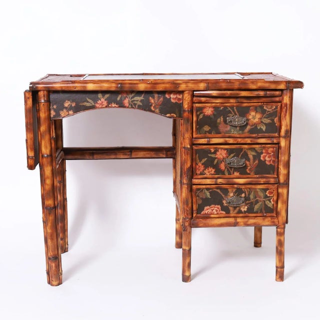 Charming 19th century three drawer desk featuring leather panels on top, foldout writing shelf, grasscloth panels on the...
