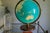 A stunning mid-century illuminated topographic globe that doubles as a table lamp. Warm walnut base, brass meridian ring,...