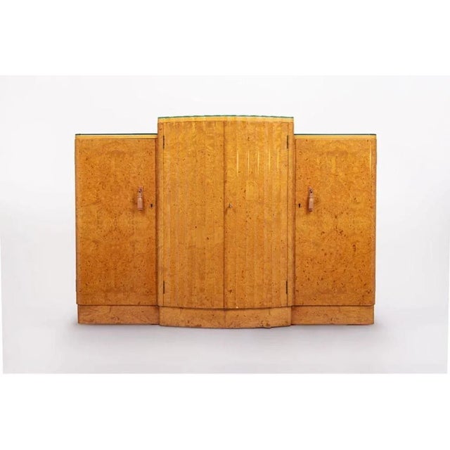 This exquisite English Art Deco maple wood bar cabinet or sideboard is attributed to Harry & Lou Epstein and is circa...