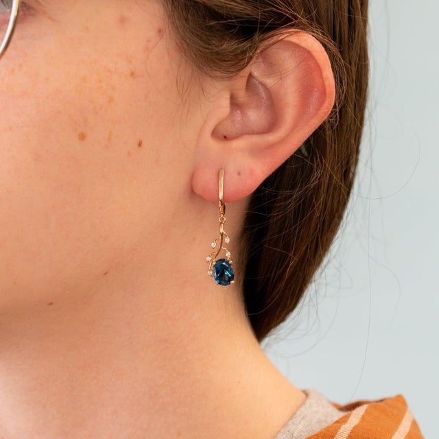 Rich London blue topaz gemstones meet warm rose gold in these oval earrings, accented with brilliant diamonds in solid 14K...
