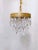 This is a 1960's chandelier with decorative brass rim draped with octagon bead chain and double pint diamond cut crustal...