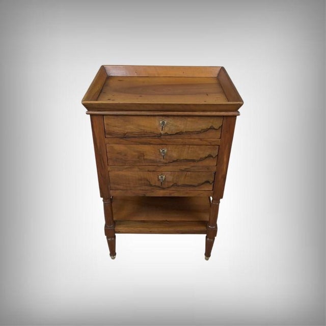 This elegant solid walnut coffee table embodies the refined simplicity of the Louis-Philippe style, with its full,...