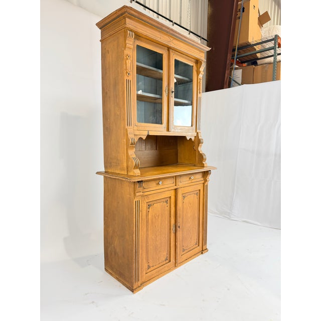 This beautiful 19th century honey pine step back hutch carries the charm of early farmhouse craftsmanship. The upper glass...