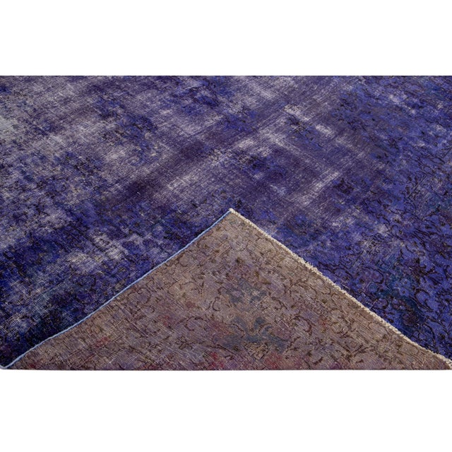 Beautiful Vintage overdyed hand-knotted oversize wool rug with a purple field. This overdyed rug has an ivory and brown...