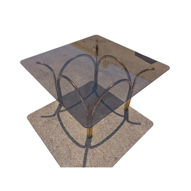 This refined square dining table perfectly embodies the glamorous aesthetic of the Hollywood Regency style, all the rage...