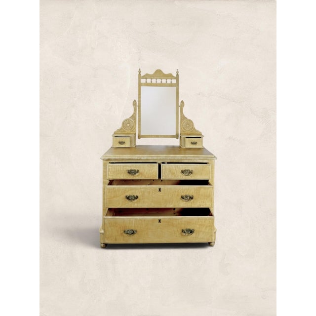 Dating to circa 1870, this English pine dressing chest retains its original scumble painted faux satin birch finish, a...