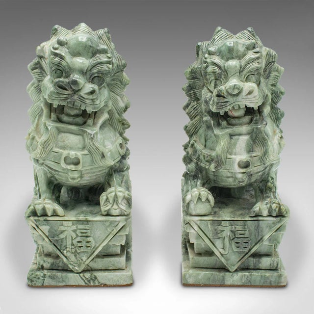 This is a pair of antique Oriental bookends. A Chinese, jade marble decorative 'Dog of Fo' book rest, dating to the late...