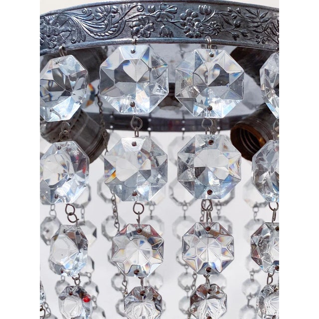 Silver plated basket chandelier with 30% leaded graduated octagon crystal chain. Rewired and restores and it has 1 Edison...