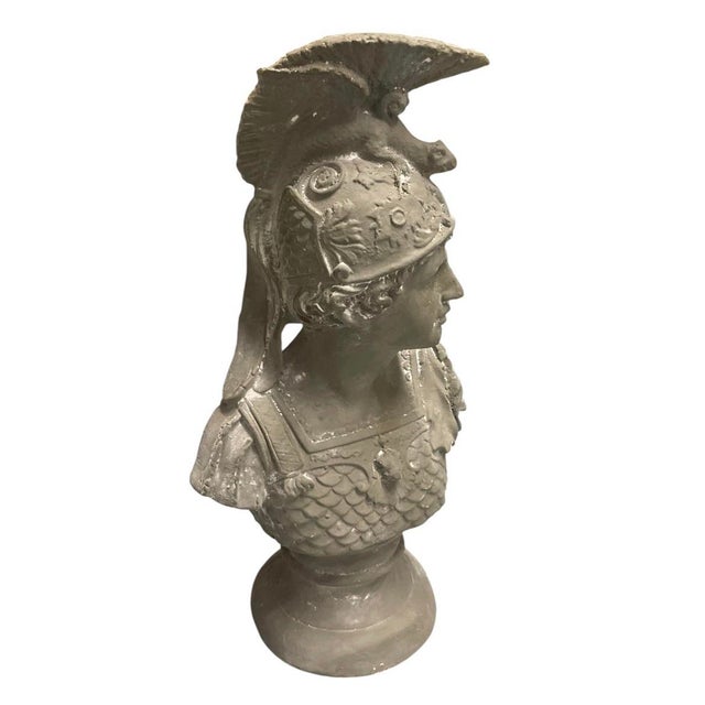 This striking cast iron bust depicts a classical Roman soldier or warrior, rendered with excellent attention to period-...