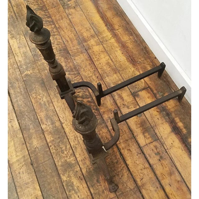 Antique brass flame torch andirons. Old brass patina.