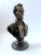 A finely modeled bronze bust of Abraham Lincoln, depicted with his characteristic solemn expression and iconic beard. The...