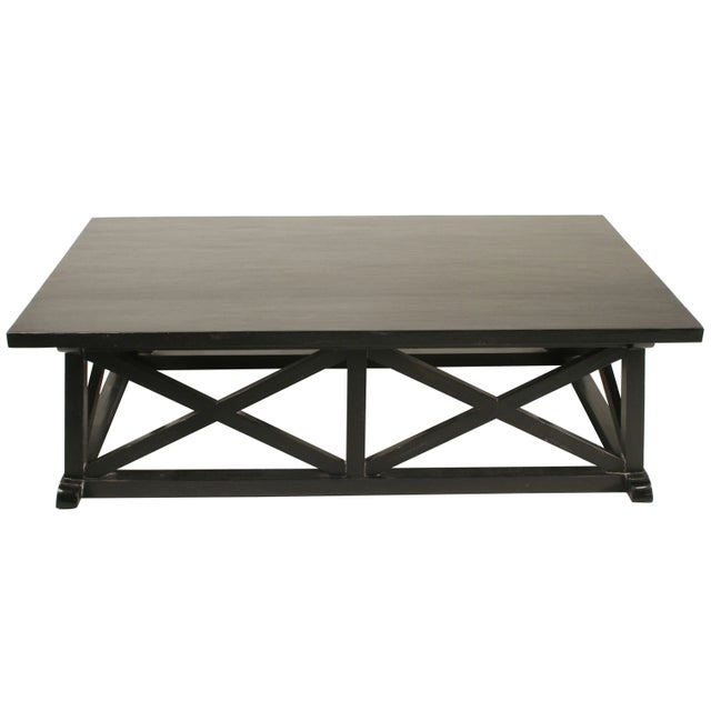 This generously sized coffee table has been hand-carved of solid mahogany enhanced with a hand -rubbed black finish,...
