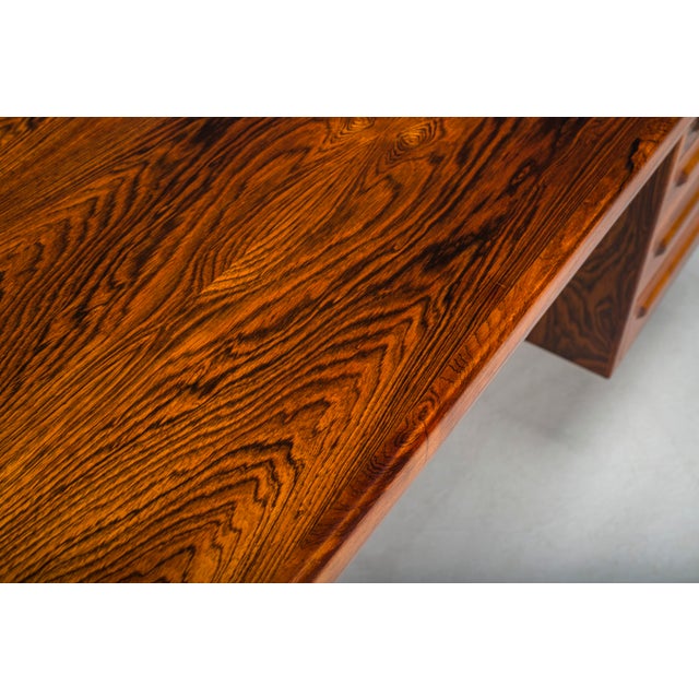 An iconic executive desk designed by Ib Kofod-Larsen for Faarup Møbelfabrik, showcasing the refined elegance of Danish...