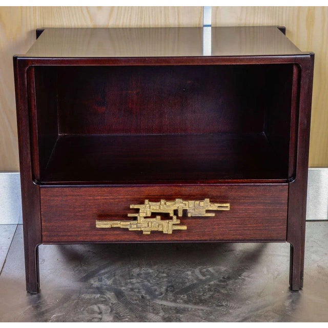 This pair of nightstands in the style of Angelo Brotto is made of rosewood with brass decorations.