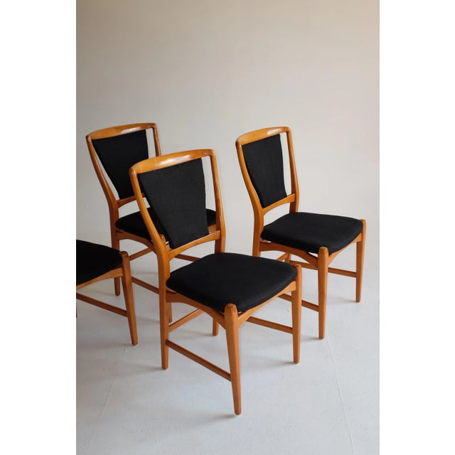 Set of 4 1950s Swedish Dining Chairs. Beautiful curved and elegant design with a contrast black linen upholstery. The...