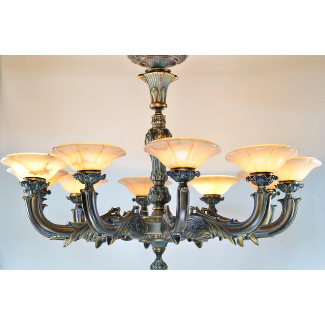 Elegant 10-arm solid bronze chandelier with genuine alabaster shades, made in Spain. Perfect for luxury dining rooms,...