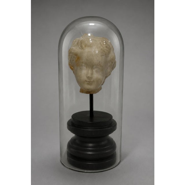 A refined Roman.. or Roman style carved marble head of a young child, Italian, 18th century or earlier, presented as a...