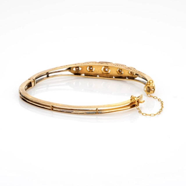Finely detailed antique Edwardian era bangle (circa 1900s to 1910s), crafted in 14k yellow gold. Old mine cut diamonds...