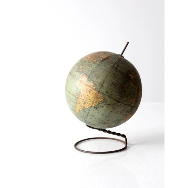 This rare C.F. Weber 6-inch globe dates to 1906. Its stand features a twisted wire circular base, creating an axis for the...