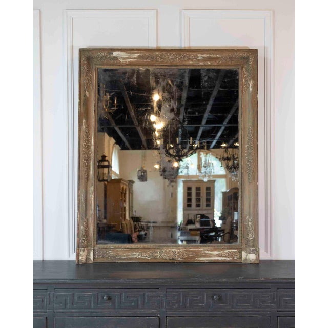 Worked in the Empire taste, this nineteenth-century French mirror carries strong neoclassical lines and retains its...
