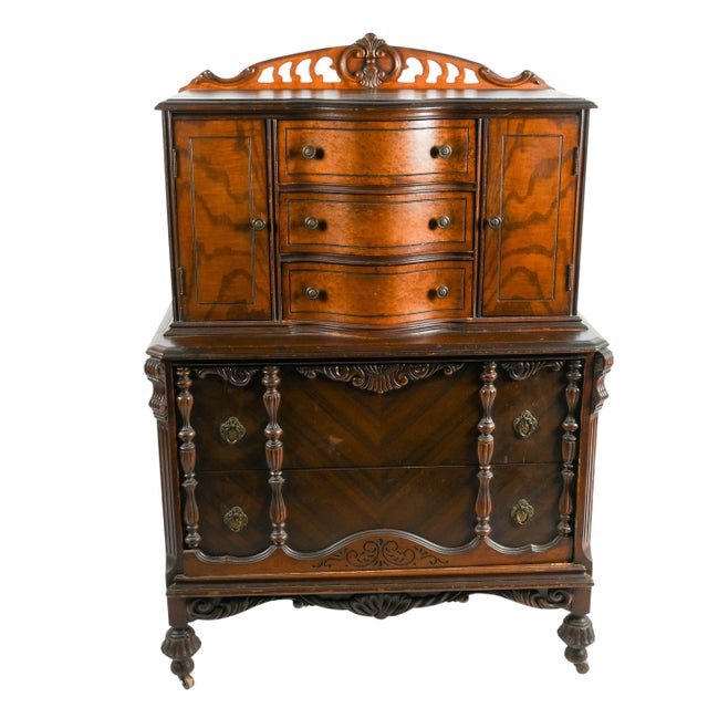 This American Art Deco Burl Wood Highboy Dresser is a striking example of early twentieth-century furniture design,...