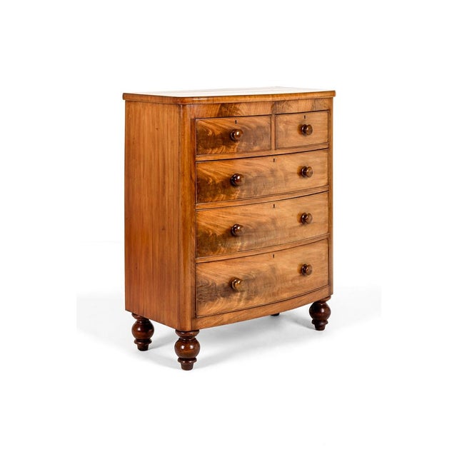 A grand mahogany bow fronted chest of drawers with an arrangement of two short over three long graduating drawers. The...