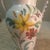 Vintage Italian pottery vase featuring a hand-painted floral design with a glossy glazed finish. Decorated with colorful...