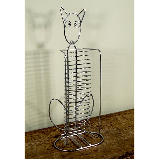 This awesome vintage 1990's chrome wire CD rack is formed in the shape of a stylized cat with an elongated body. The piece...